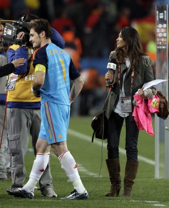 Spain goalkeeper Iker Casillas, left, walks away after an interview with Spanish TV journalist Sara Carbonero, right, at the end of the World Cup quarterfinal soccer match between Paraguay and Spain at Ellis Park Stadium in Johannesburg, South Africa, Saturday, July 3, 2010. Spain won 1-0. (AP Photo/Ivan Sekretarev)